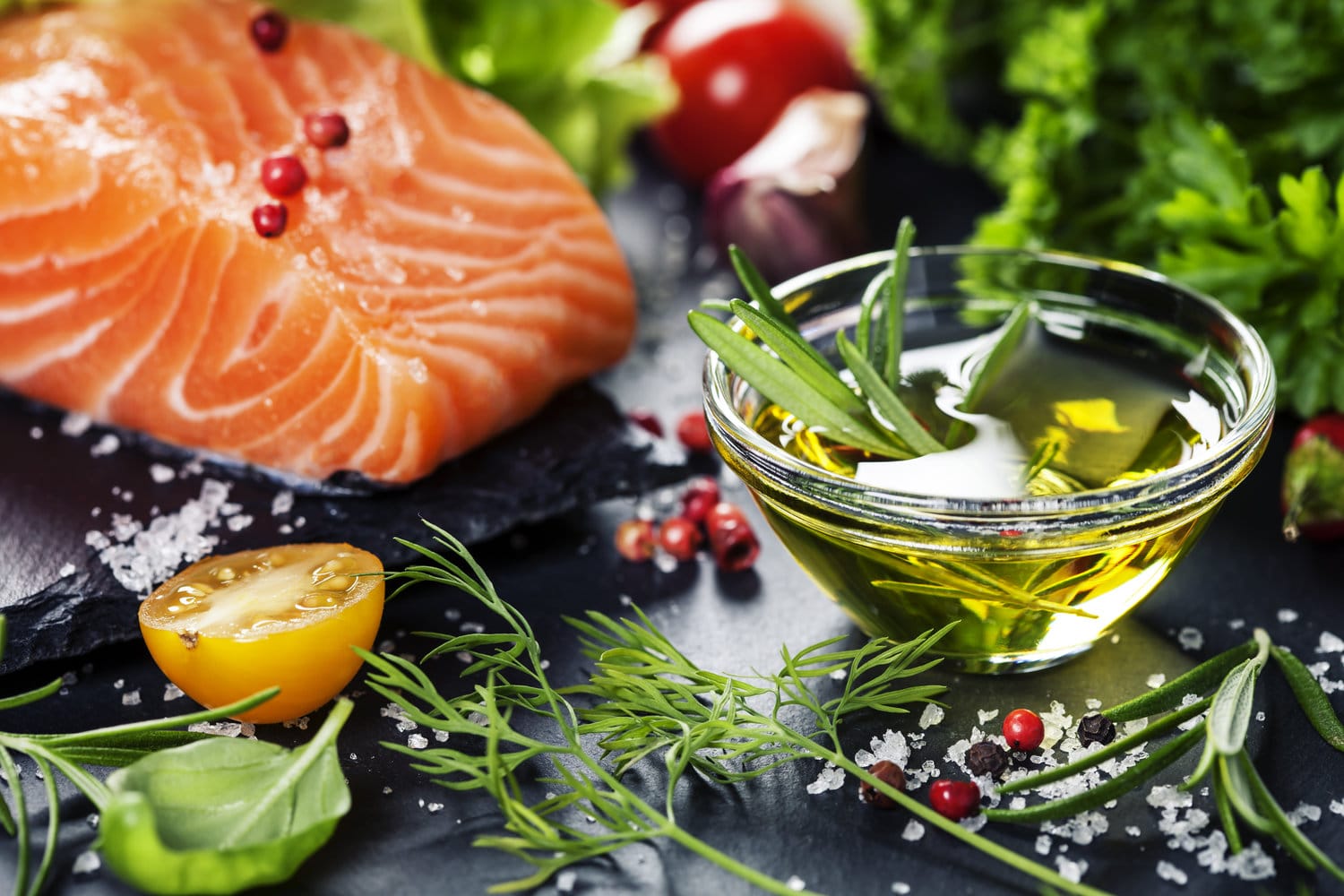 Portion of fresh salmon fillet with aromatic herbs, spices and vegetables