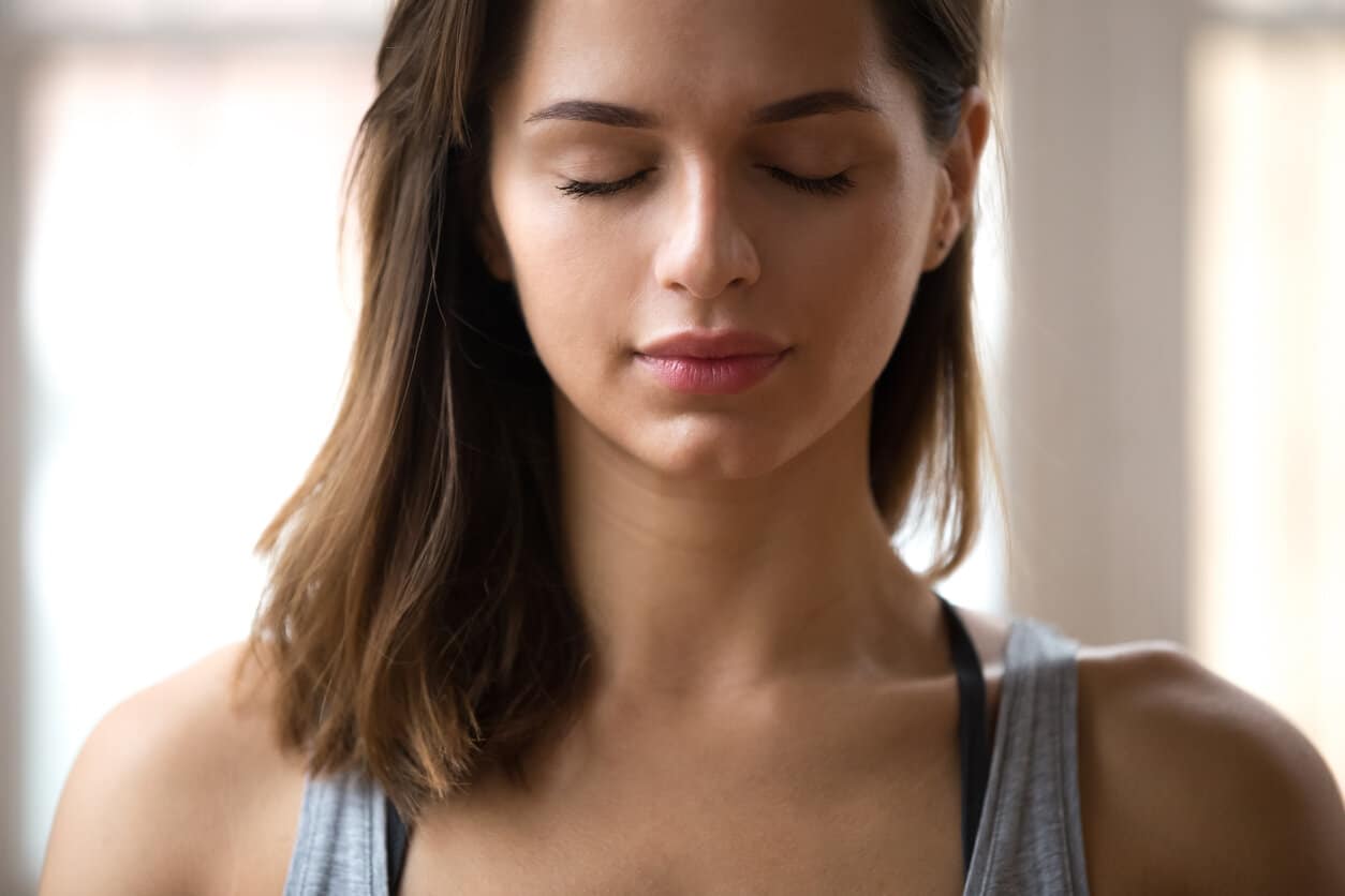 Woman meditating doing restorative yoga exercise