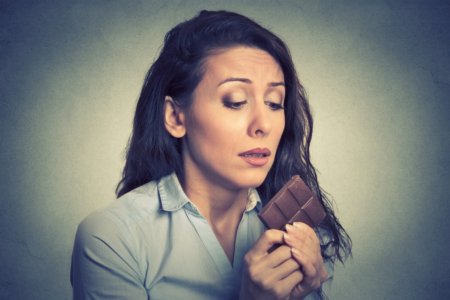 Woman trying to self control against chocolate