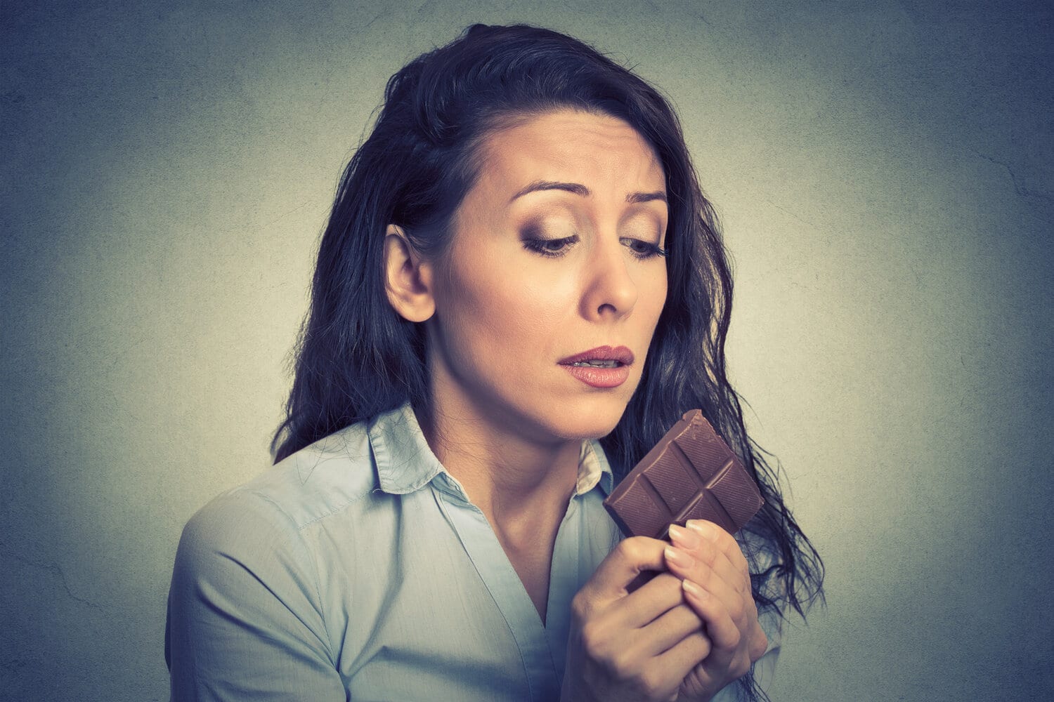 Woman trying to self control against chocolate 