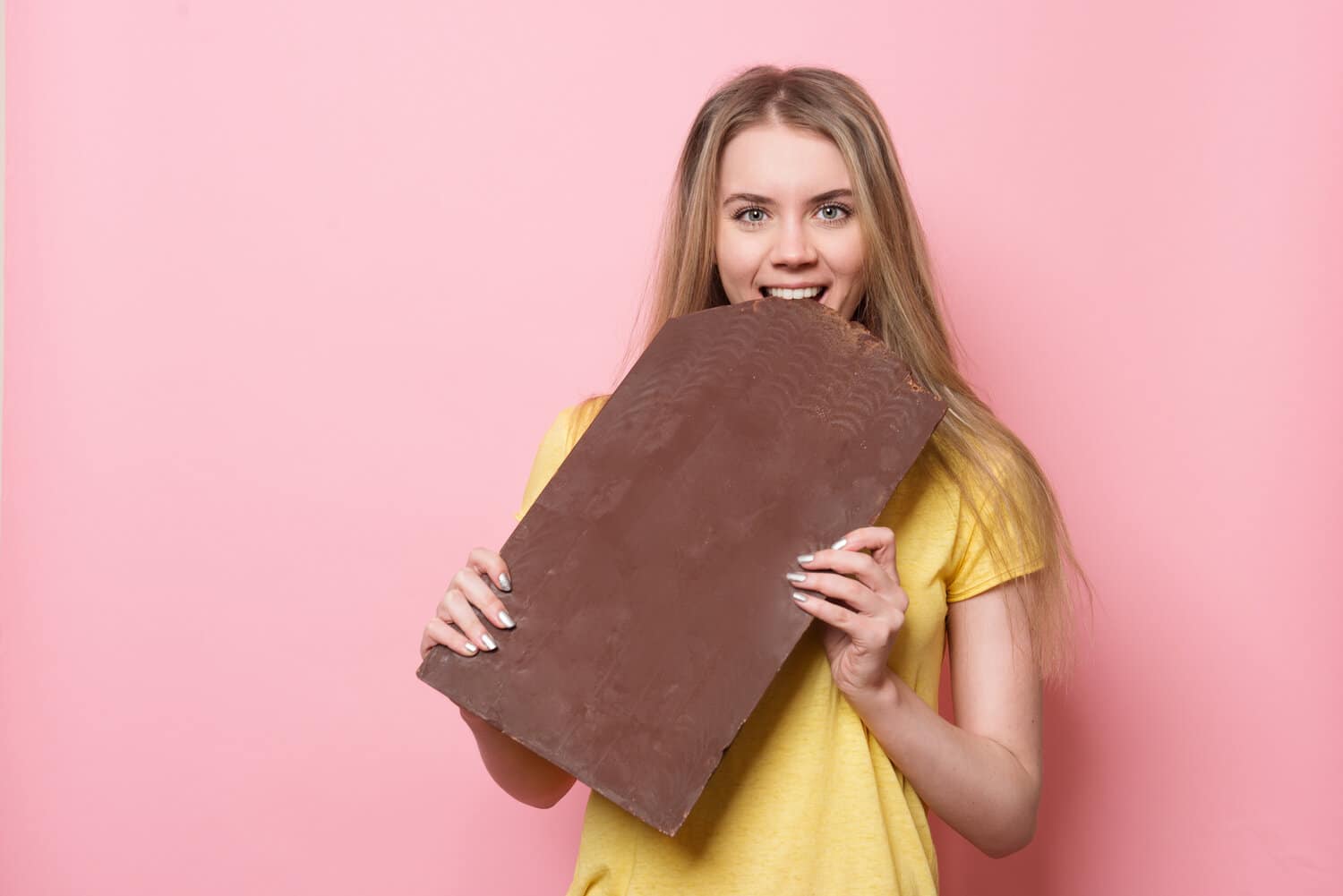 Woman eating a big Dark Chocolate